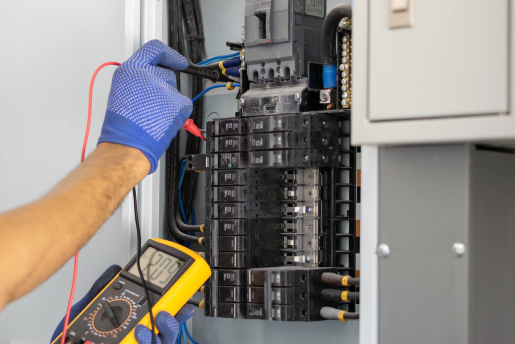 Electrician-in-the-building-testing-fuse-box