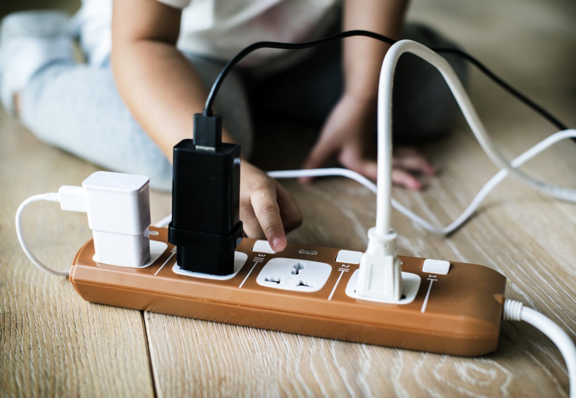 Toddler playing with dangerous electrical plug